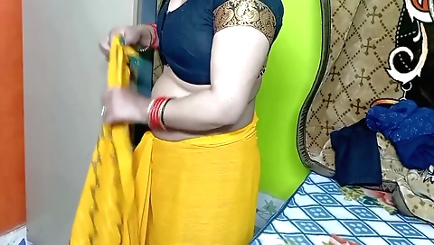 Indian beauty in yellow sari moves around on solo video