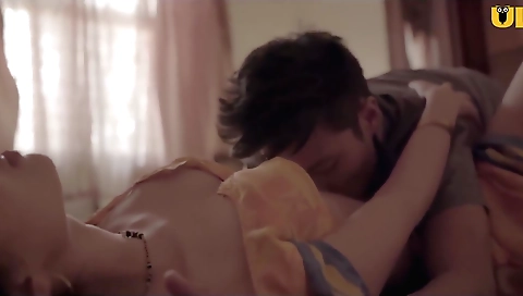 Big-titted brunette girl on bed with her clothes on