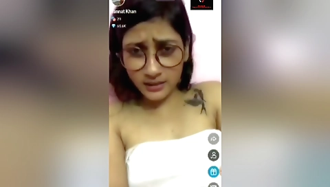 Tattooed woman in a white dress shows off her curves