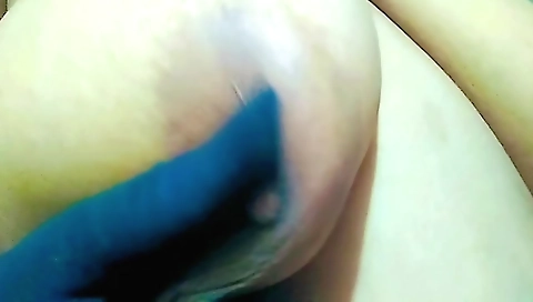 Slutty brunette in a sexy dress riding her long dildo