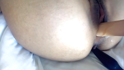 Amateur girl with a hairy pussy fucks her ass on webcam