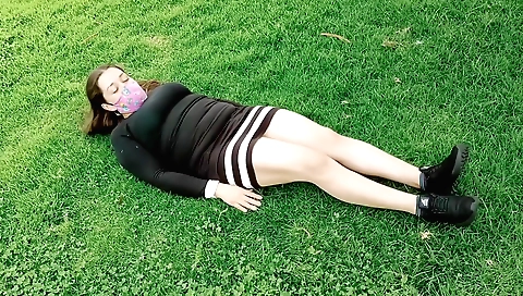 Amateur brunette showing her big tits and ass in a park