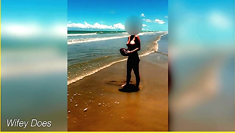 Solo female in a bikini plays football on the beach