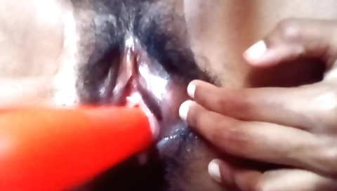 Indian housewife is getting penetrated by a large dildo